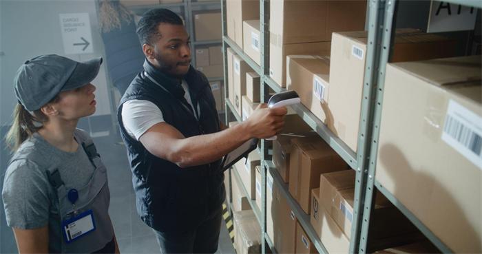 Warehouse staff scanning wholesale cigarette shipment before dispatch (2)